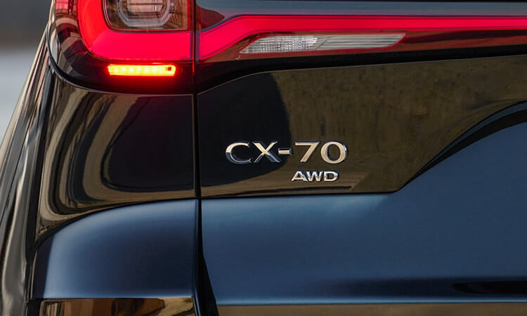 Closeup of the “CX-70 AWD” badge on the rear liftgate.