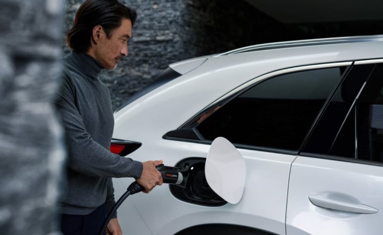 Man charging an electric Mazda