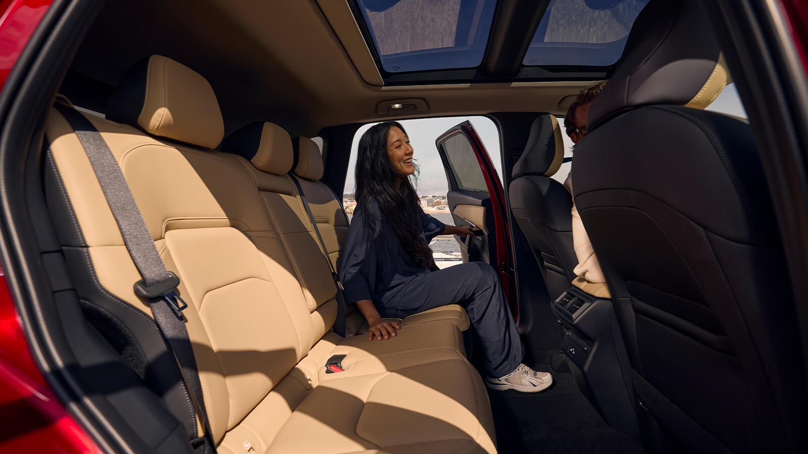 Close-up of a person driving a Mazda CX-5 with one hand on the steering wheel, focused on the road.