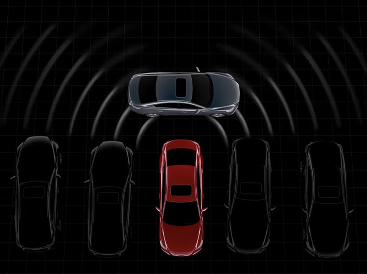 Overhead view of red Mazda backing out from line of parked cars in silhouette with rear milliwave radar detecting passing car.