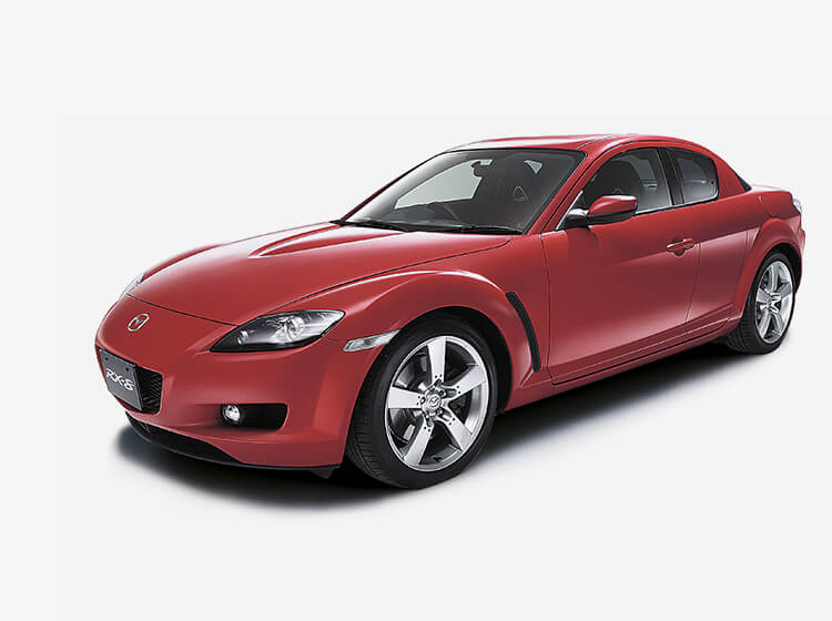 Red Mazda RX-8 sports car on white background viewed from in front of passenger headlight.