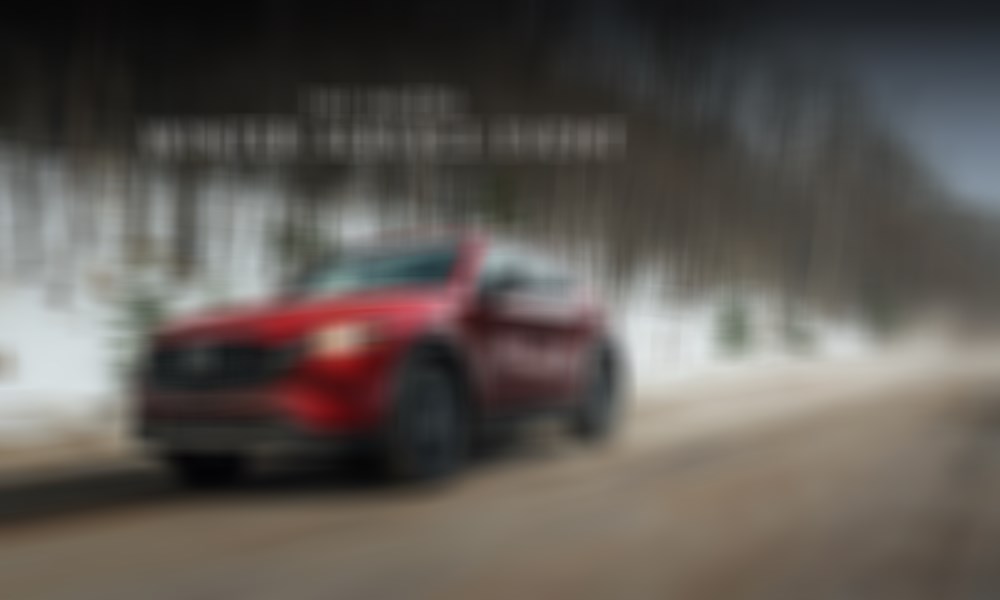 A Mazda CX-5 driving on a snowy road