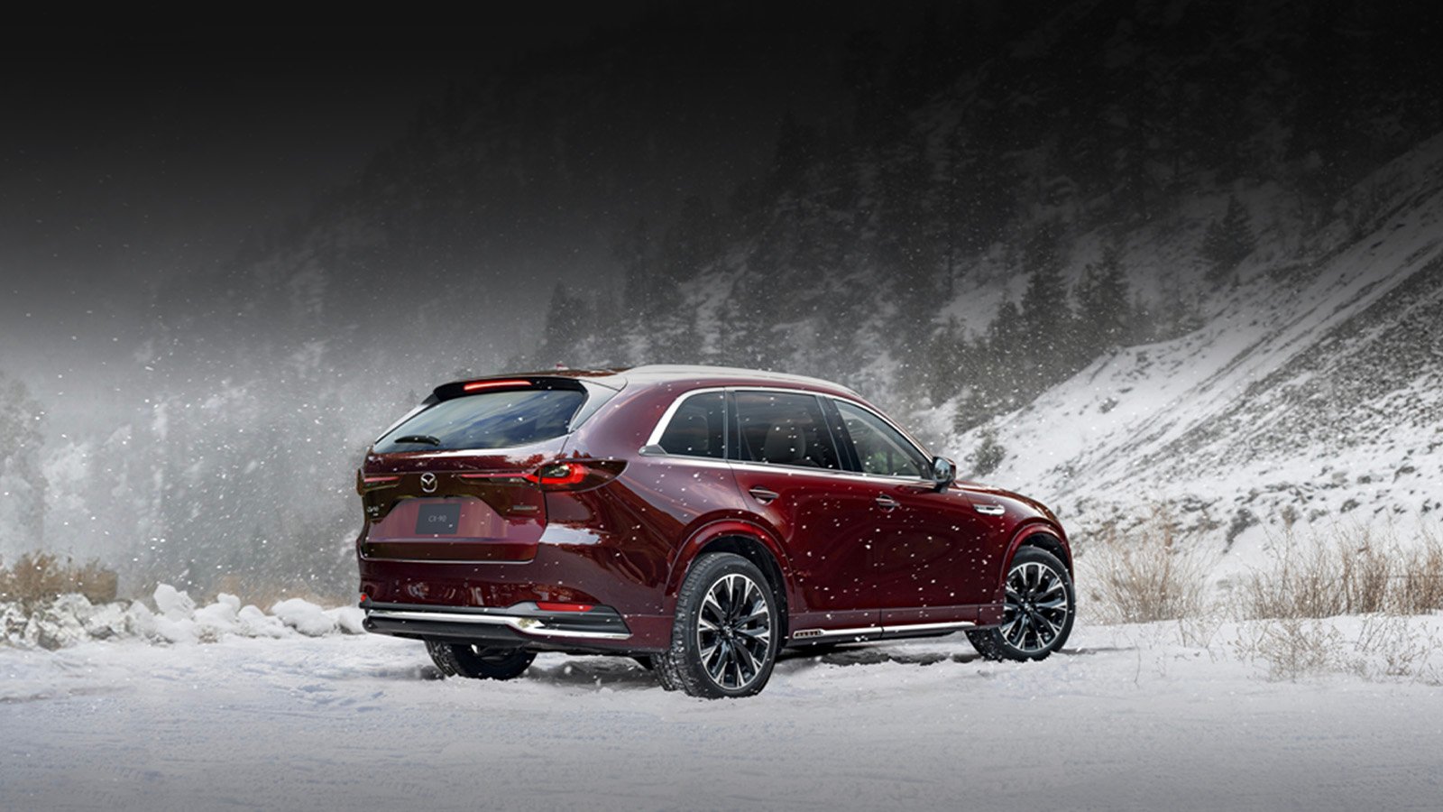 A Mazda CX-90 driving on a snowy road