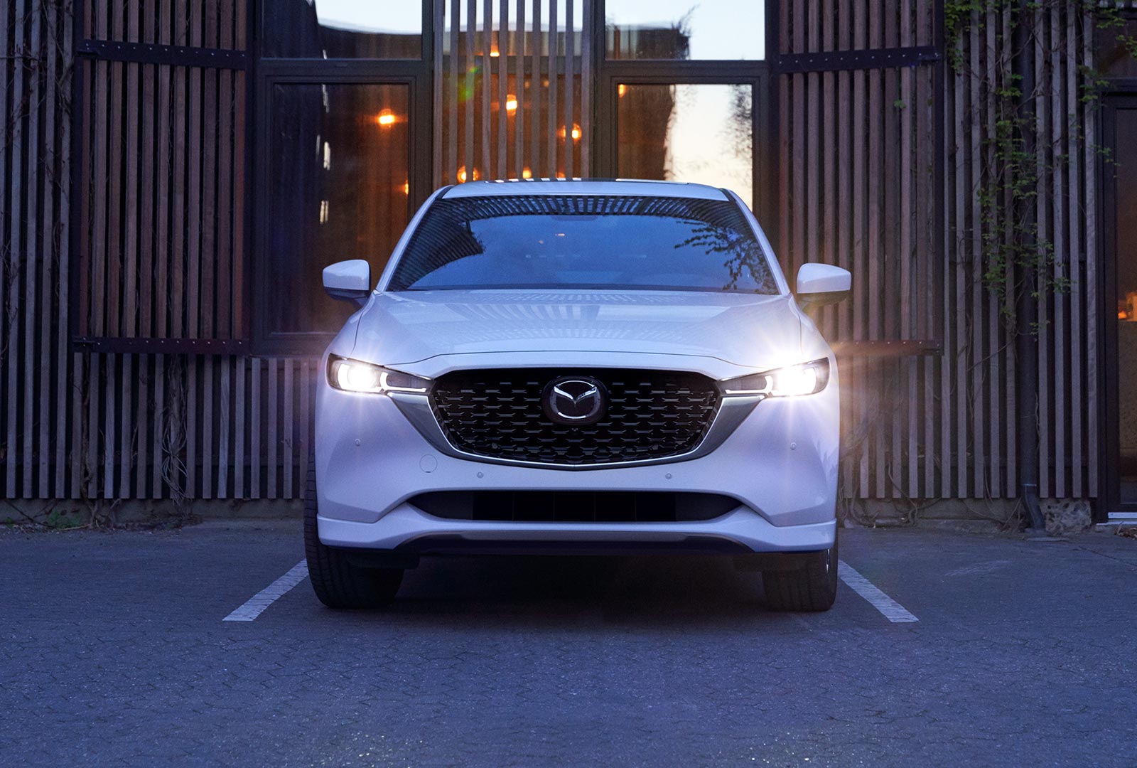 Front view of Snowflake White Pearl CX-5 parked in shade.