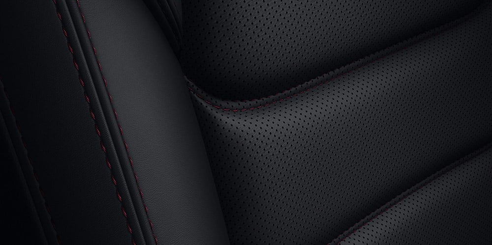 Close up of Black leather with Red stitching accents. 