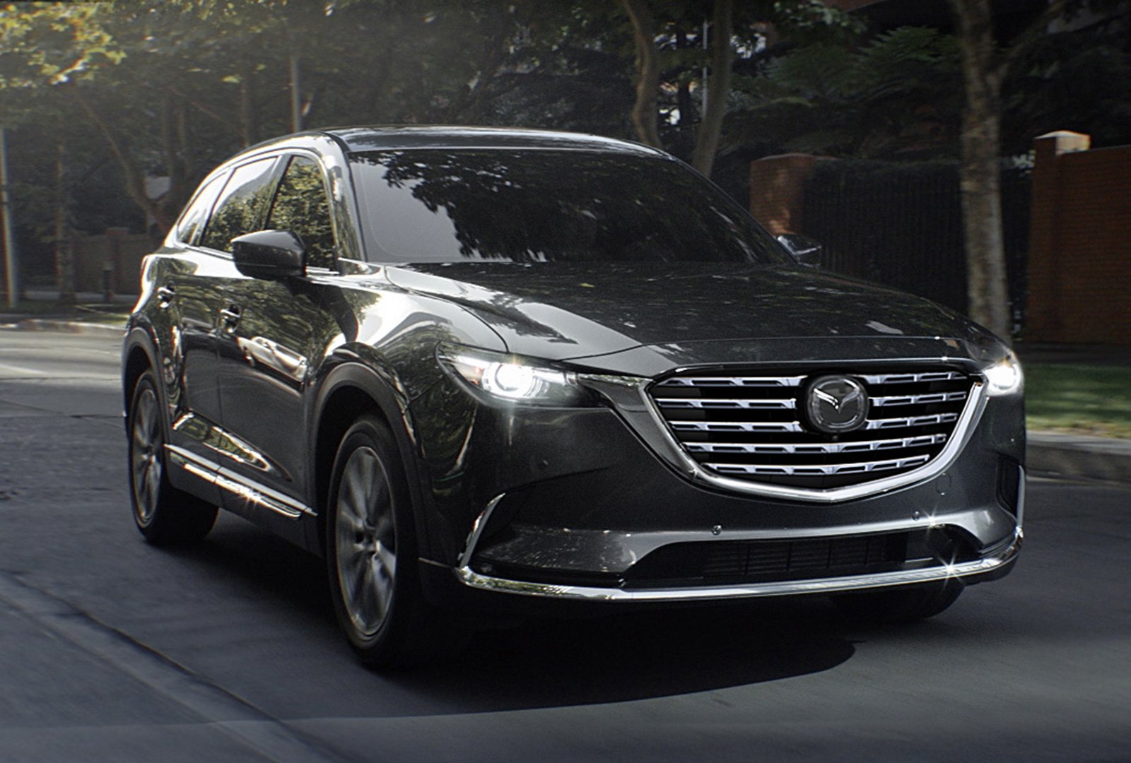 Mazda CX-9 approaches with headlights on