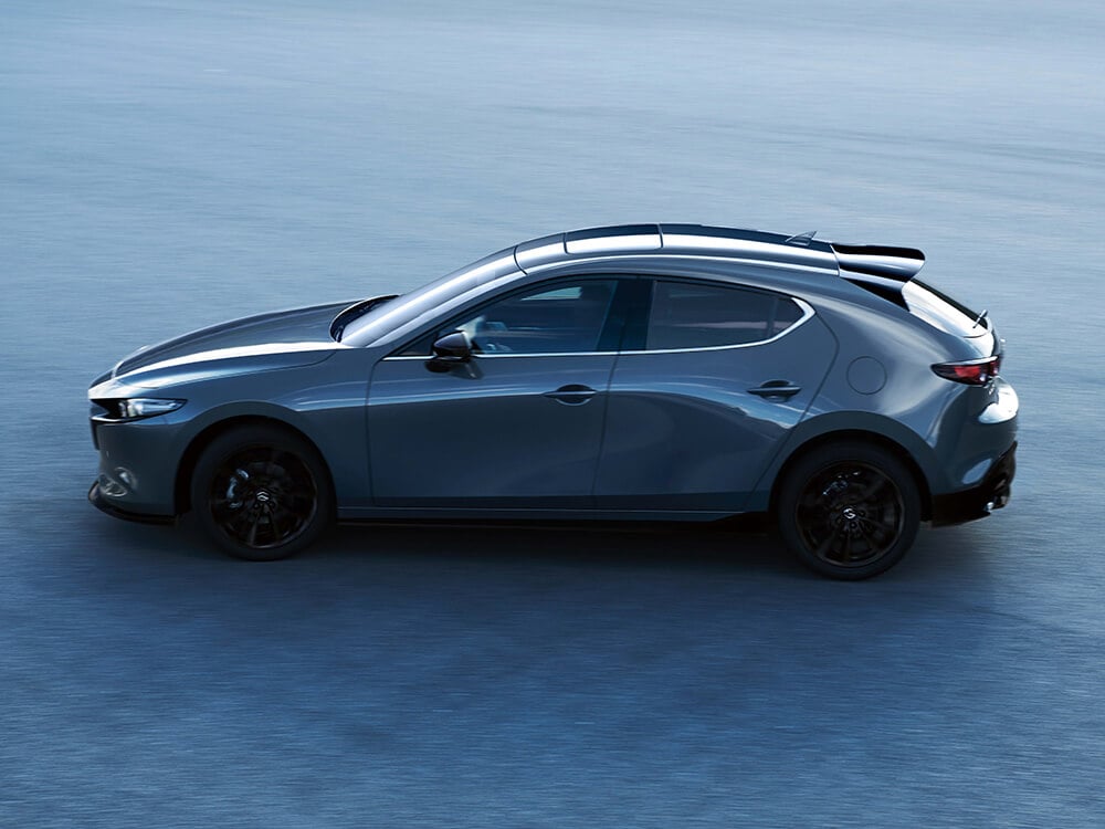 Deep Crystal Blue Mica Mazda3 Sport parked in shallow blue water