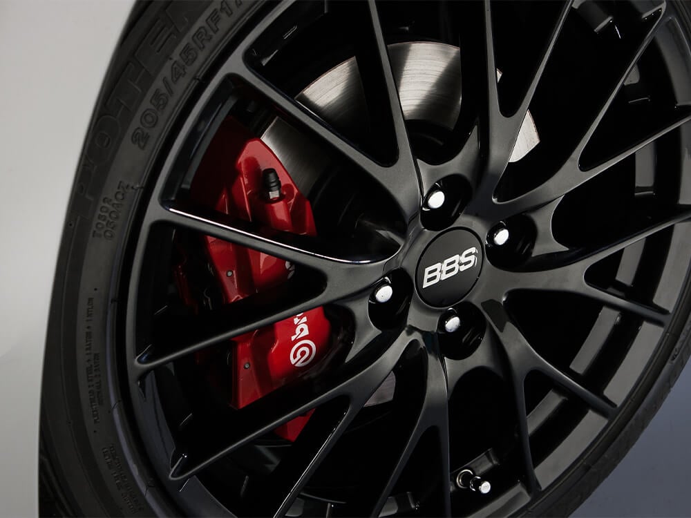 “17-inch BBS® forged wheels (dark finish) with red-painted front and rear brake calipers.”