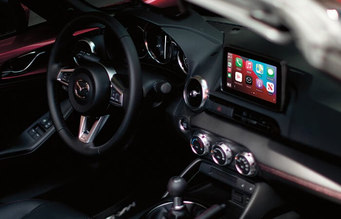 MX-5 cockpit with steering wheel, display screen and HMI Commander control.