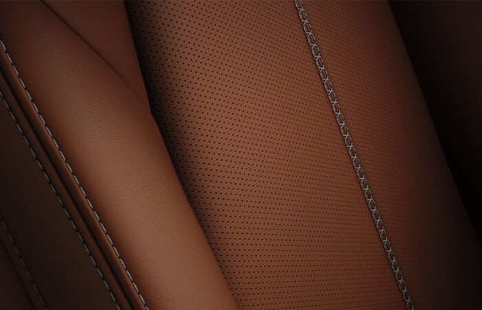 Close-up of Terracotta Nappa Leather seat with grey stitching.