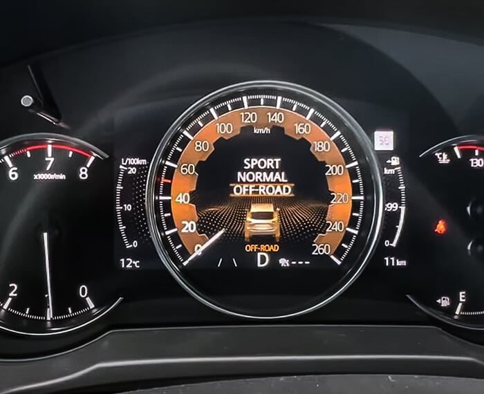 Closeup of CX-5 digital dash displaying Mi-Drive modes, Off-road selected. 