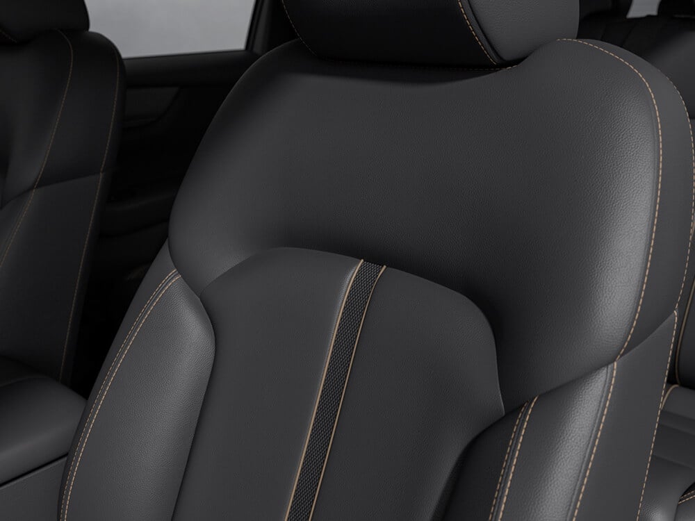 Closeup of black leatherette front seat texture and stitching.