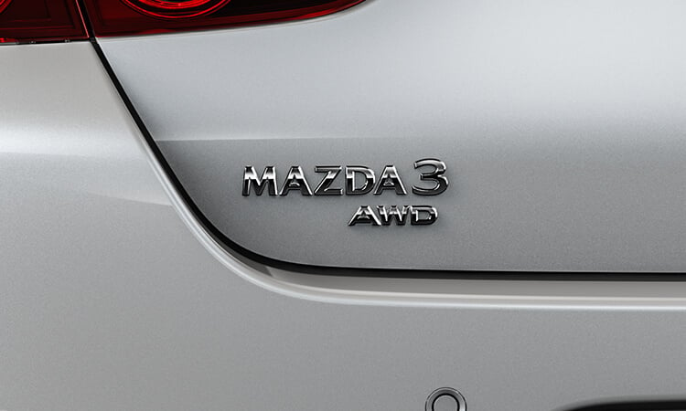 Closeup of Mazda3 sedan AWD badge. 