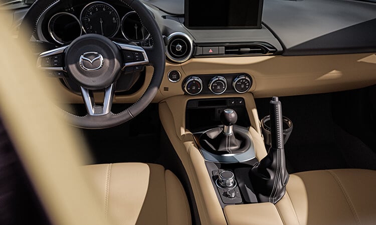 View inside the MX-5 RF with Tan leather interior focuses on the Human Machine Interface controls in the centre console.