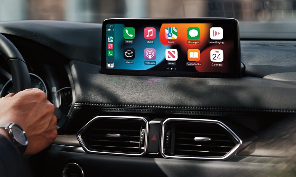 Mazda CX-5 interior showing display and steering wheel controls.