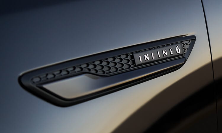 Closeup of exterior “Inline 6” badge.