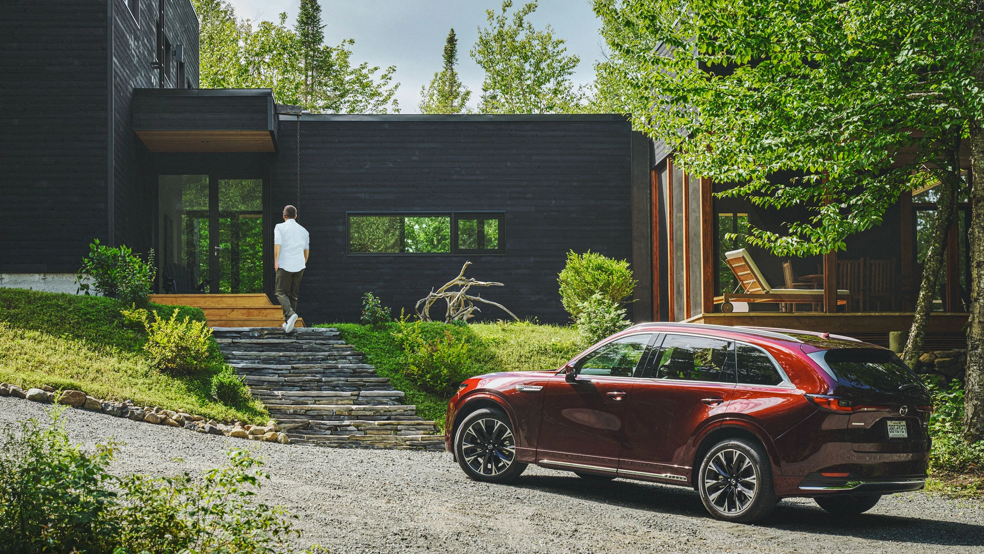 A Mazda vehicle driving down a road on Fogo Island.