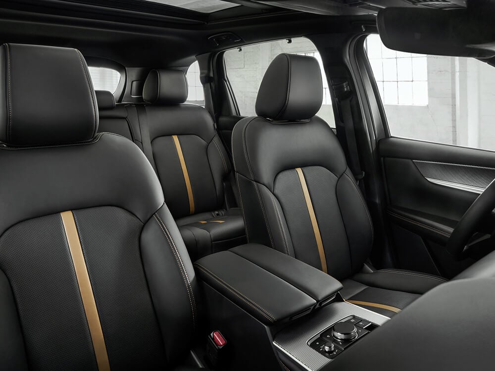 Full interior shot of first and second rows inside a CX-90 with a Black Leatherette interior.